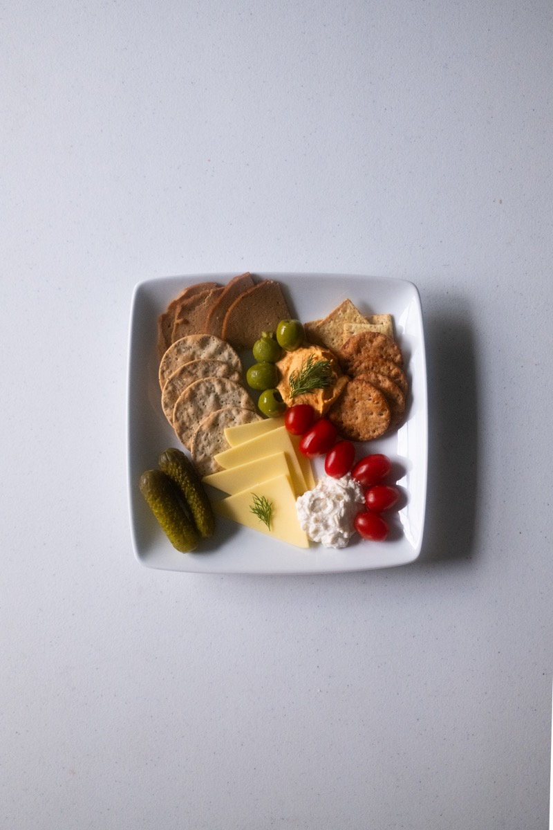 Small cheese and cracker plate with pickles